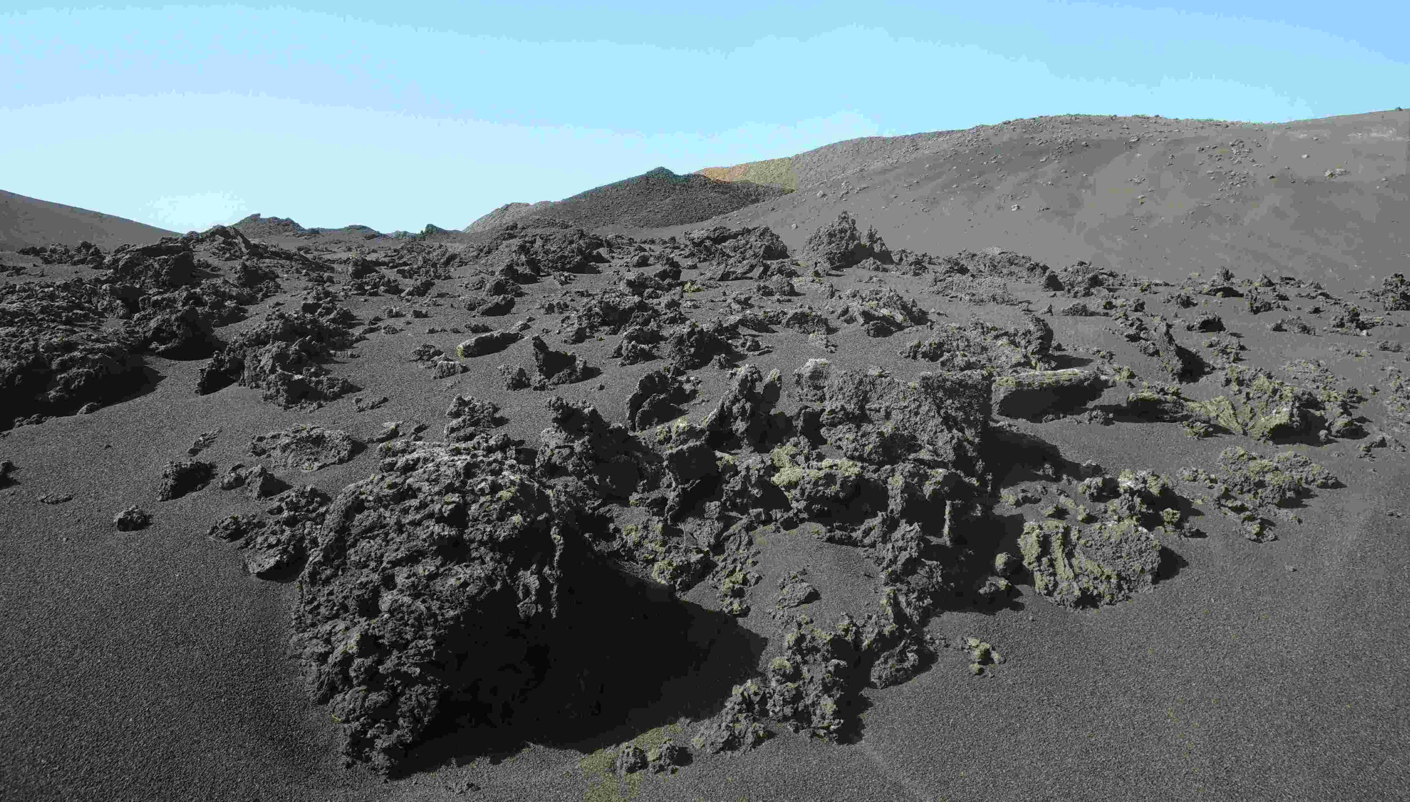A desert with lots of lava rock and lava ash