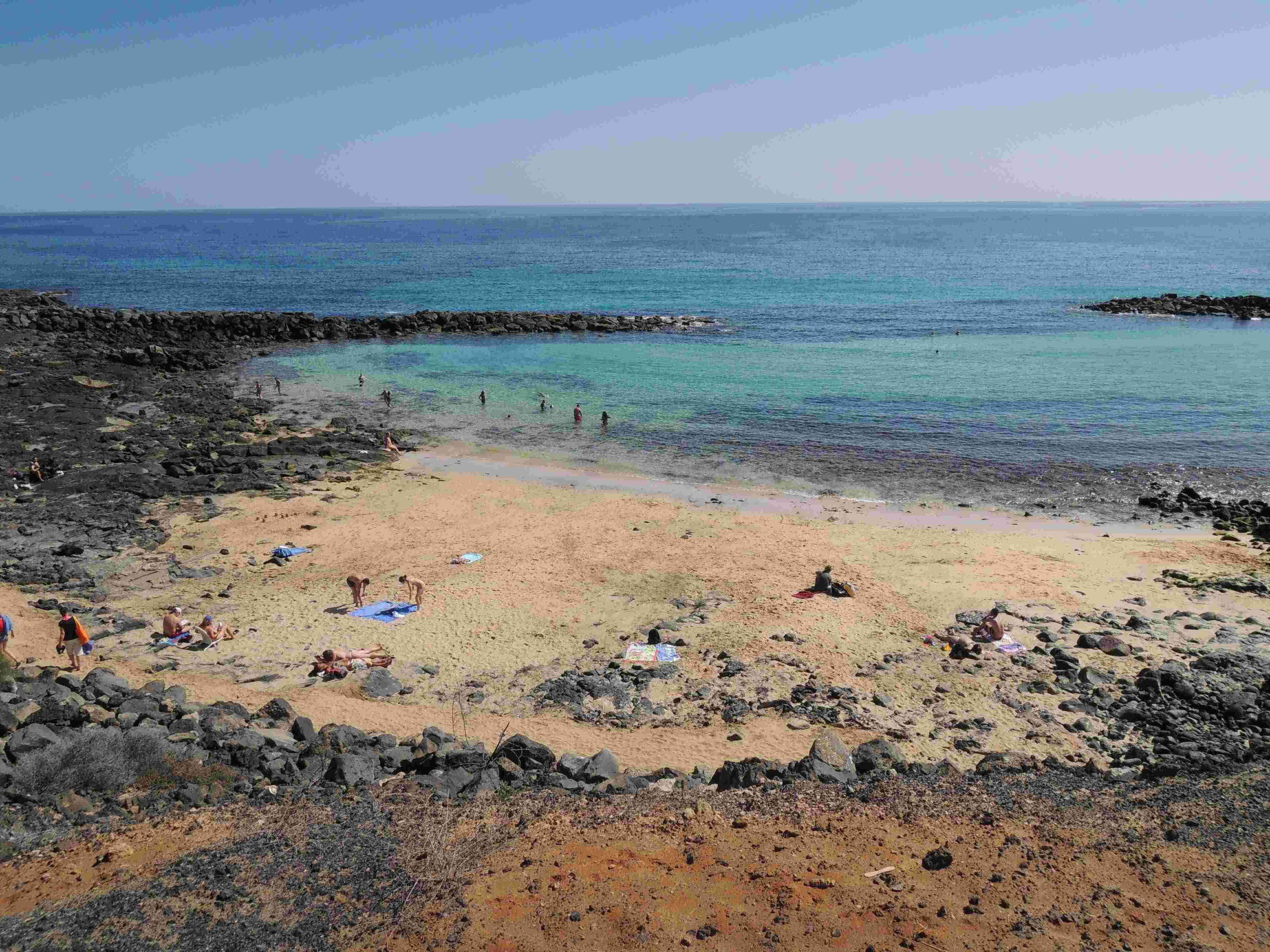 Some sandy beach can be found amidst the lava