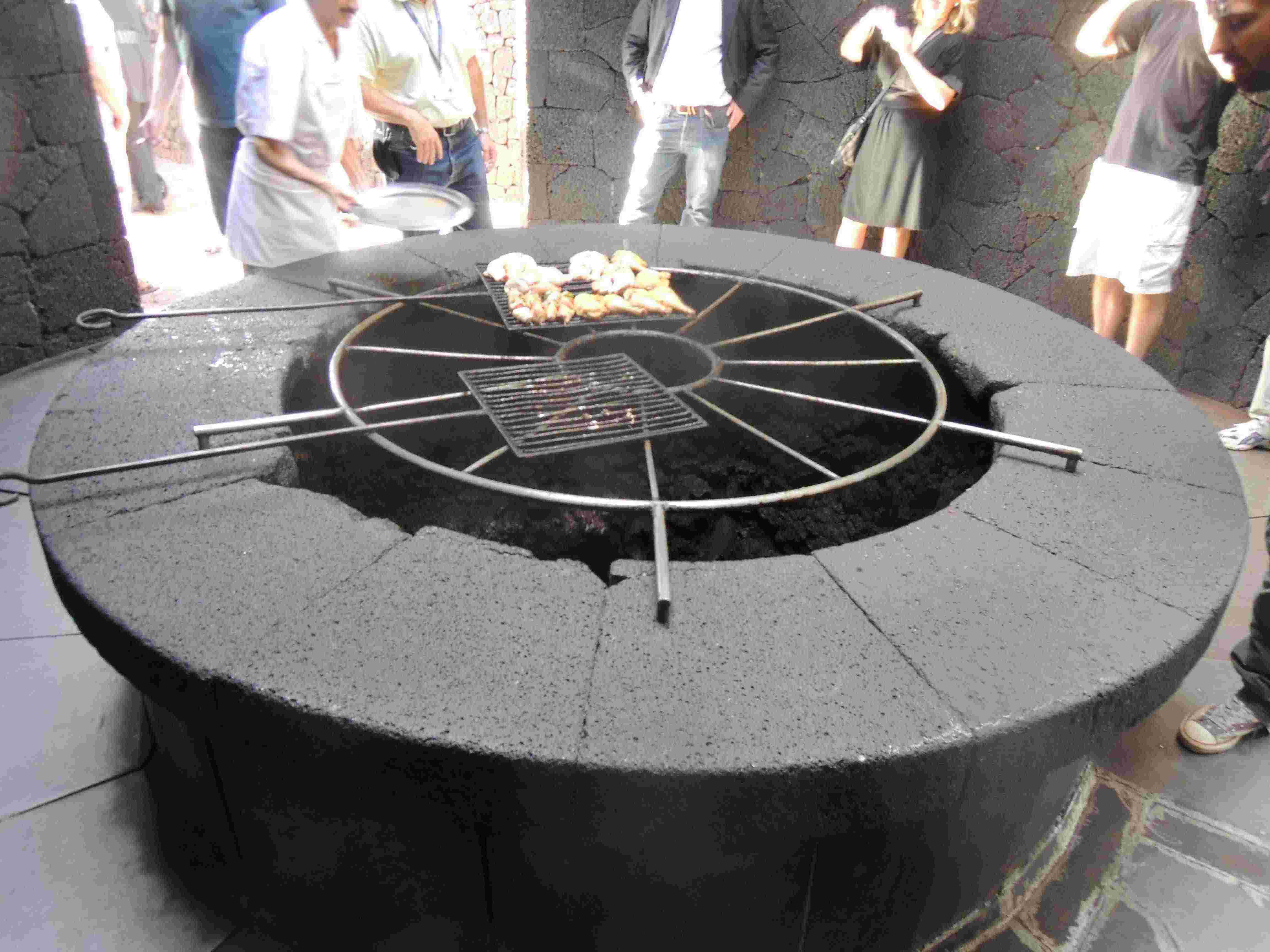 Tourists are shown how a grill near hot lava can cook chicken